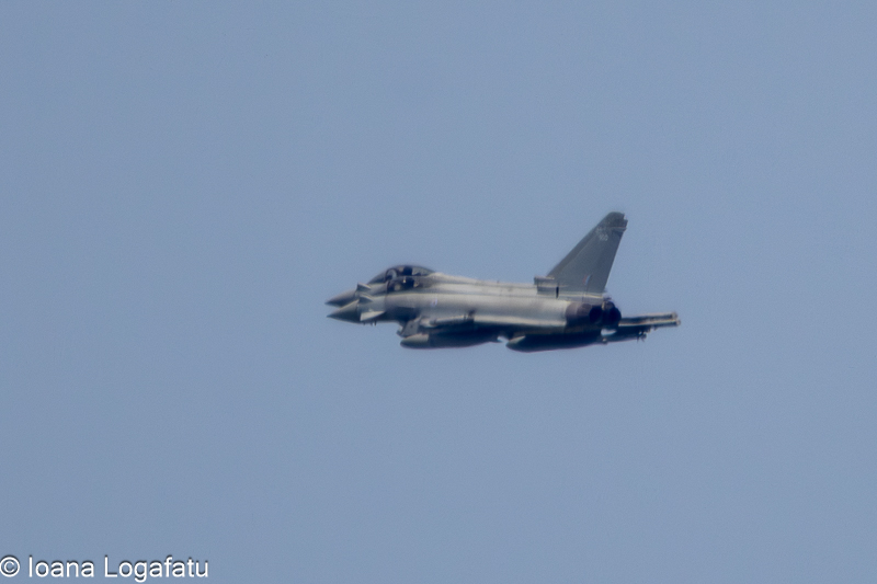 Jet soaring high above the clouds in a clear sky